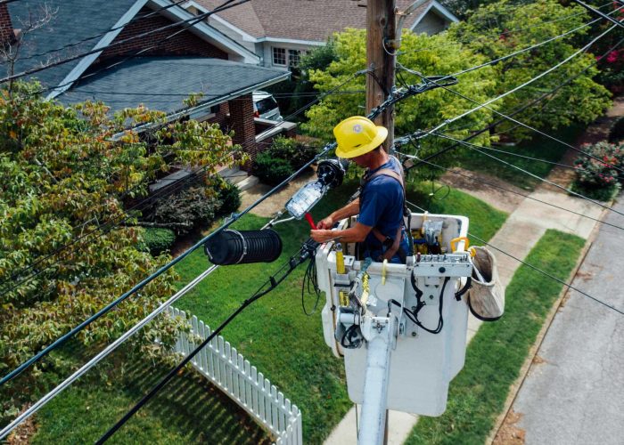 Photography of Man Repairing Electrical Wires